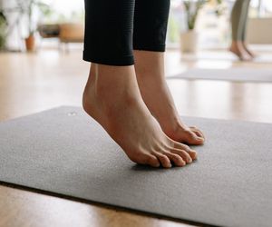 A close-up shot of feet on a mat, ready for exercise.