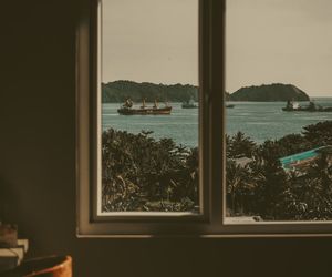 View from a window overlooking a calm natural landscape.